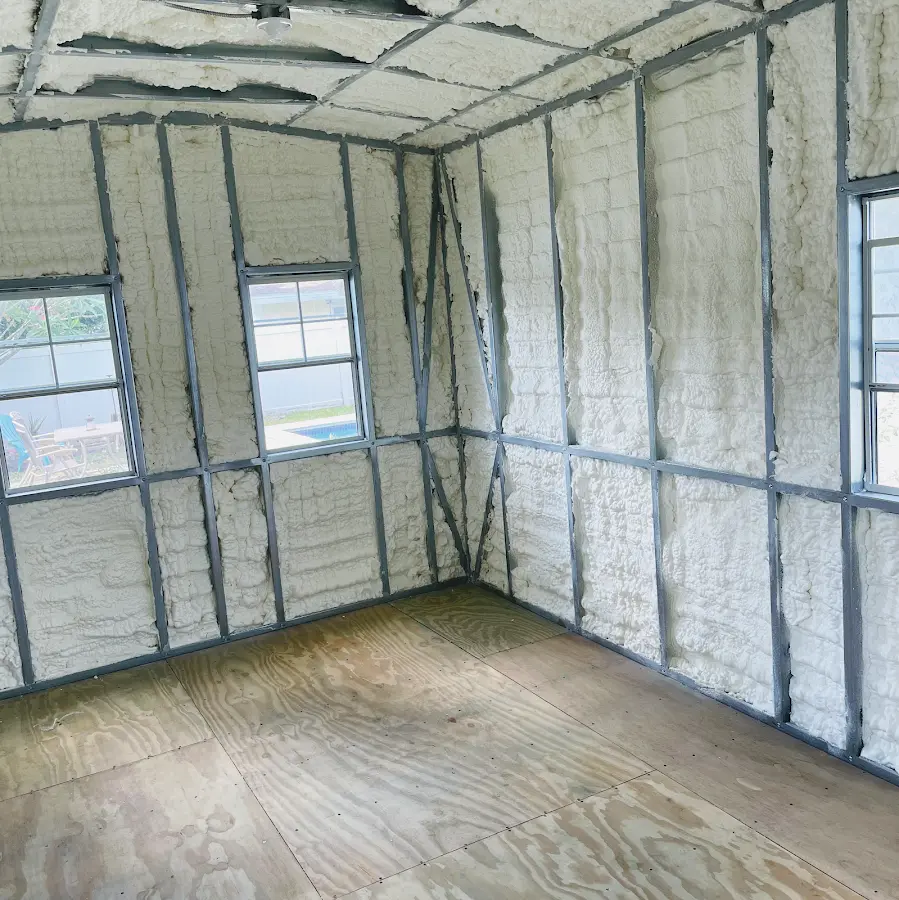 Closed-cell spray foam insulation applied to wall cavities in a residential project in Emporia